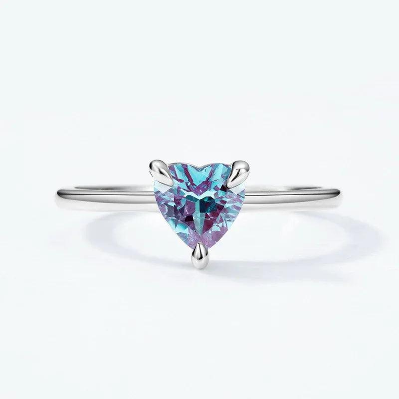 Trillion-cut Alexandrite solitaire ring, center stone close-up on a white background