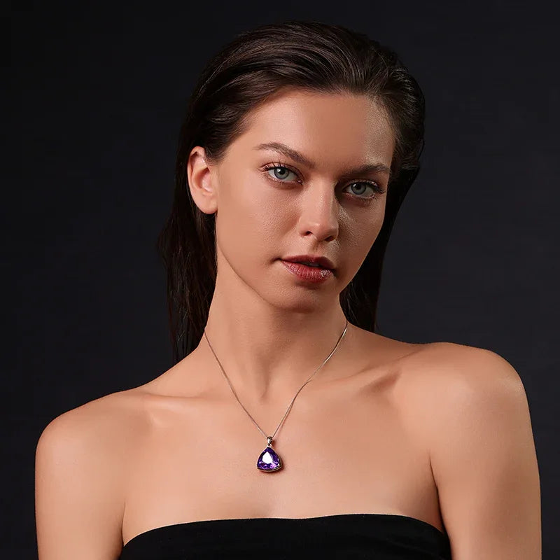 trillion-cut amethyst pendant necklace worn at the neckline in a close-up