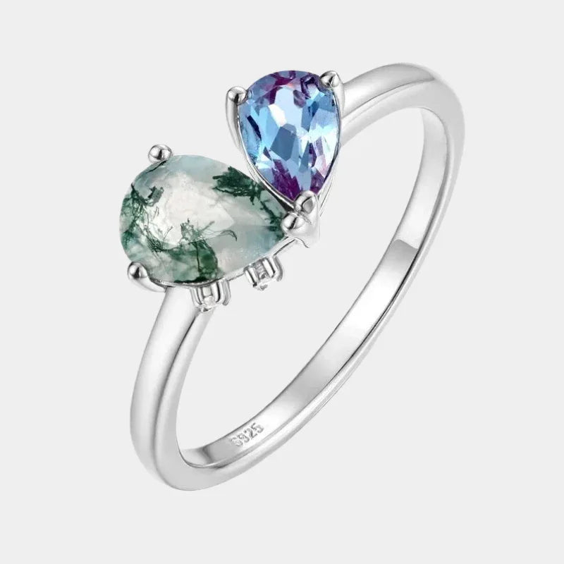 Two-stone Alexandrite open ring in pale green and blue-purple tones, front product view on a white background