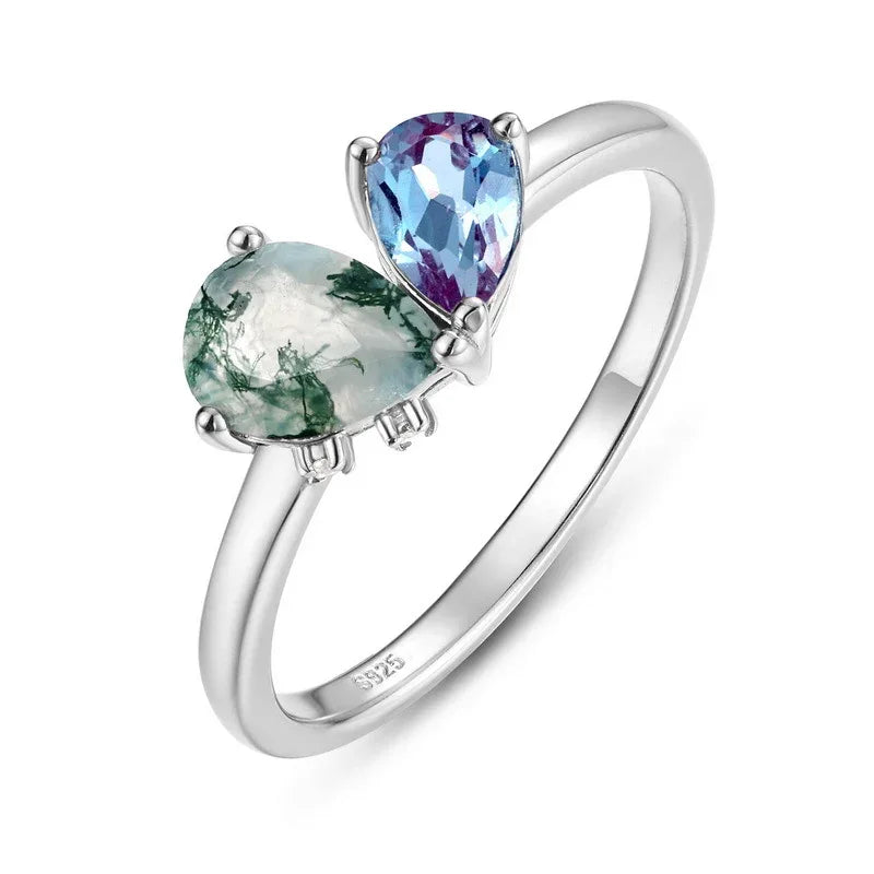 Two-stone Alexandrite open ring in pale green and blue-purple tones, alternate front product view on a white background