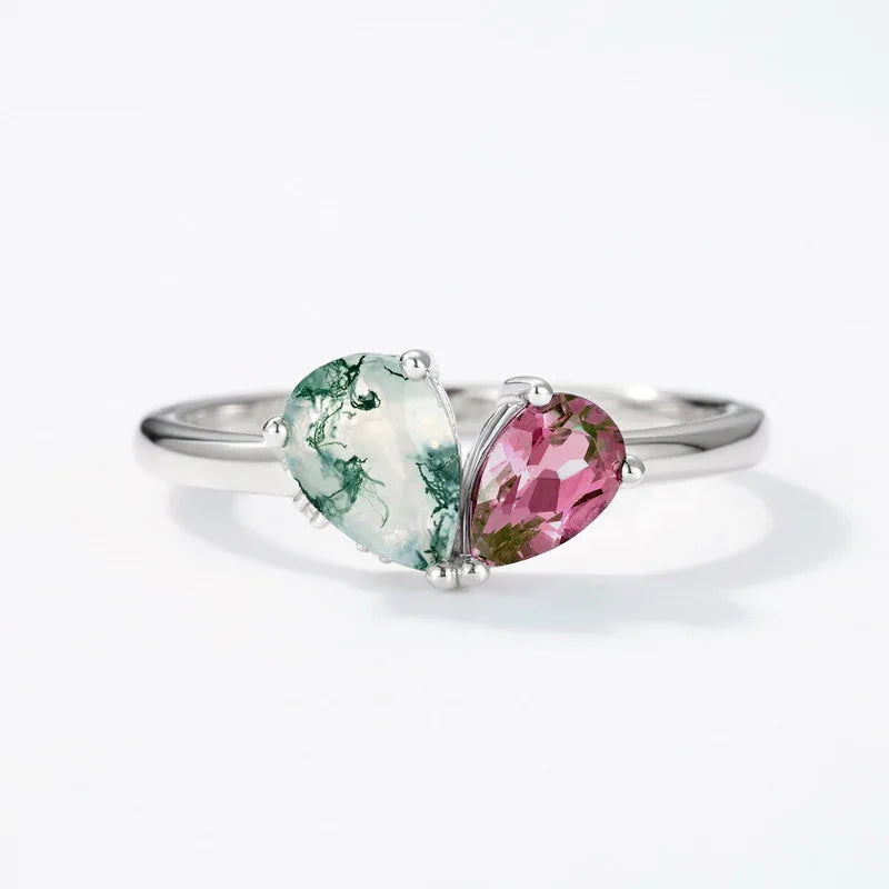 Two-stone Alexandrite open ring in pale green and blue-purple tones, pink-toned Alexandrite view under alternate lighting