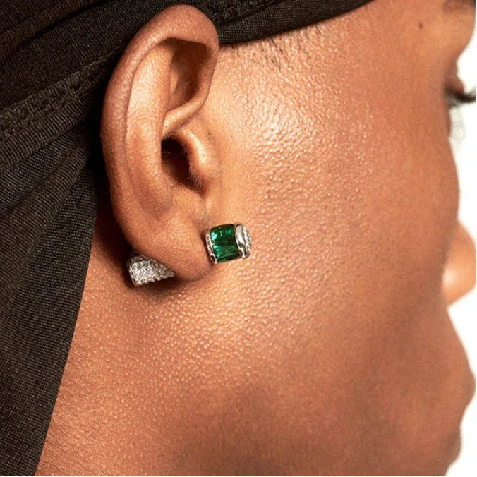 Two-Tone Emerald Cylindrical Stud Earrings worn on the ear in a close-up
