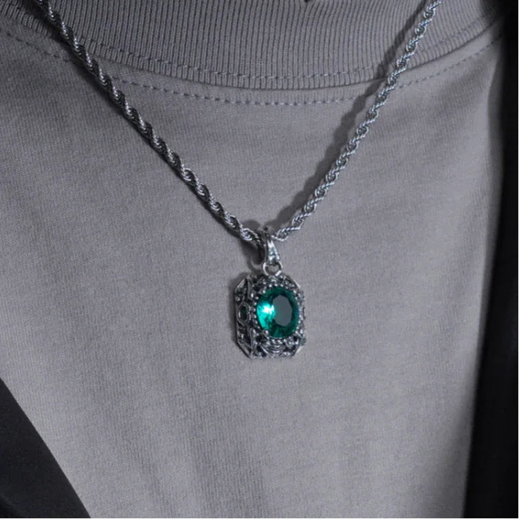 Vintage-Style Emerald Halo Pendant Necklace worn at the neckline in a close-up