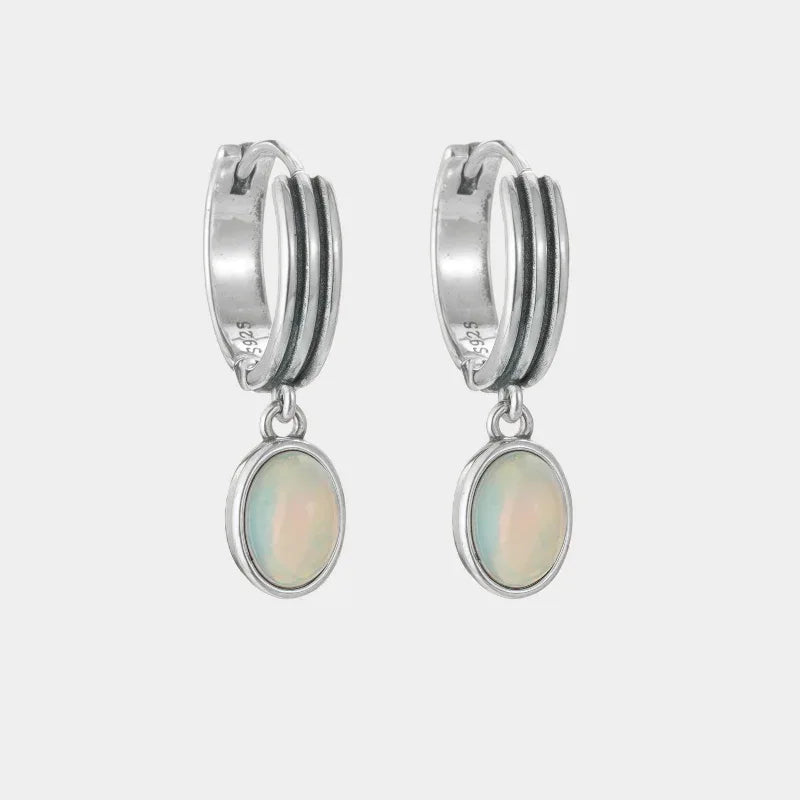 White Opal Drop Huggie Earrings front product view on a light background