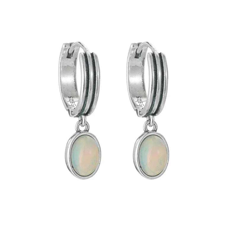 White Opal Drop Huggie Earrings worn on the hand