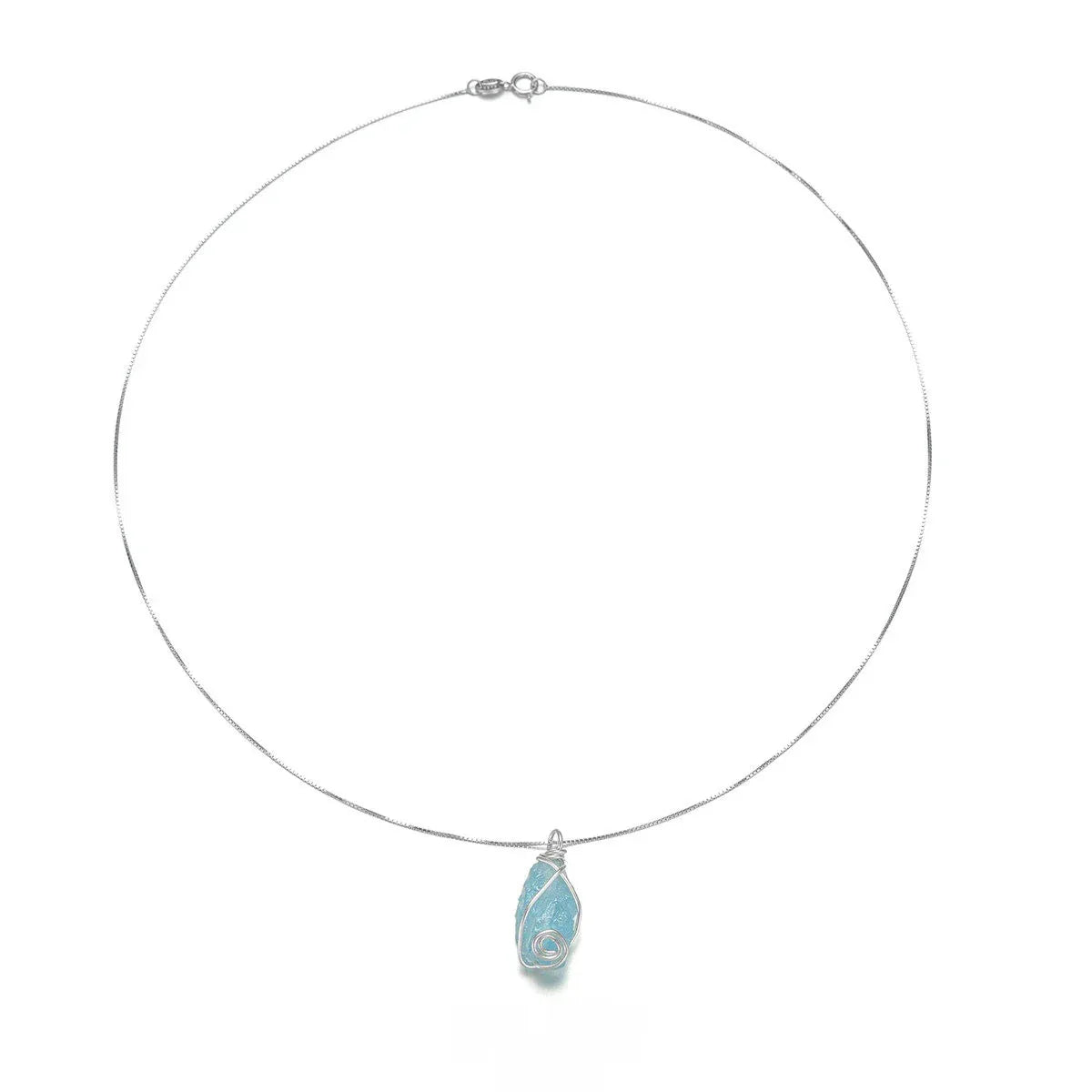 Wire-Wrapped Raw Aquamarine Pendant Necklace pendant and chain detail on a light background